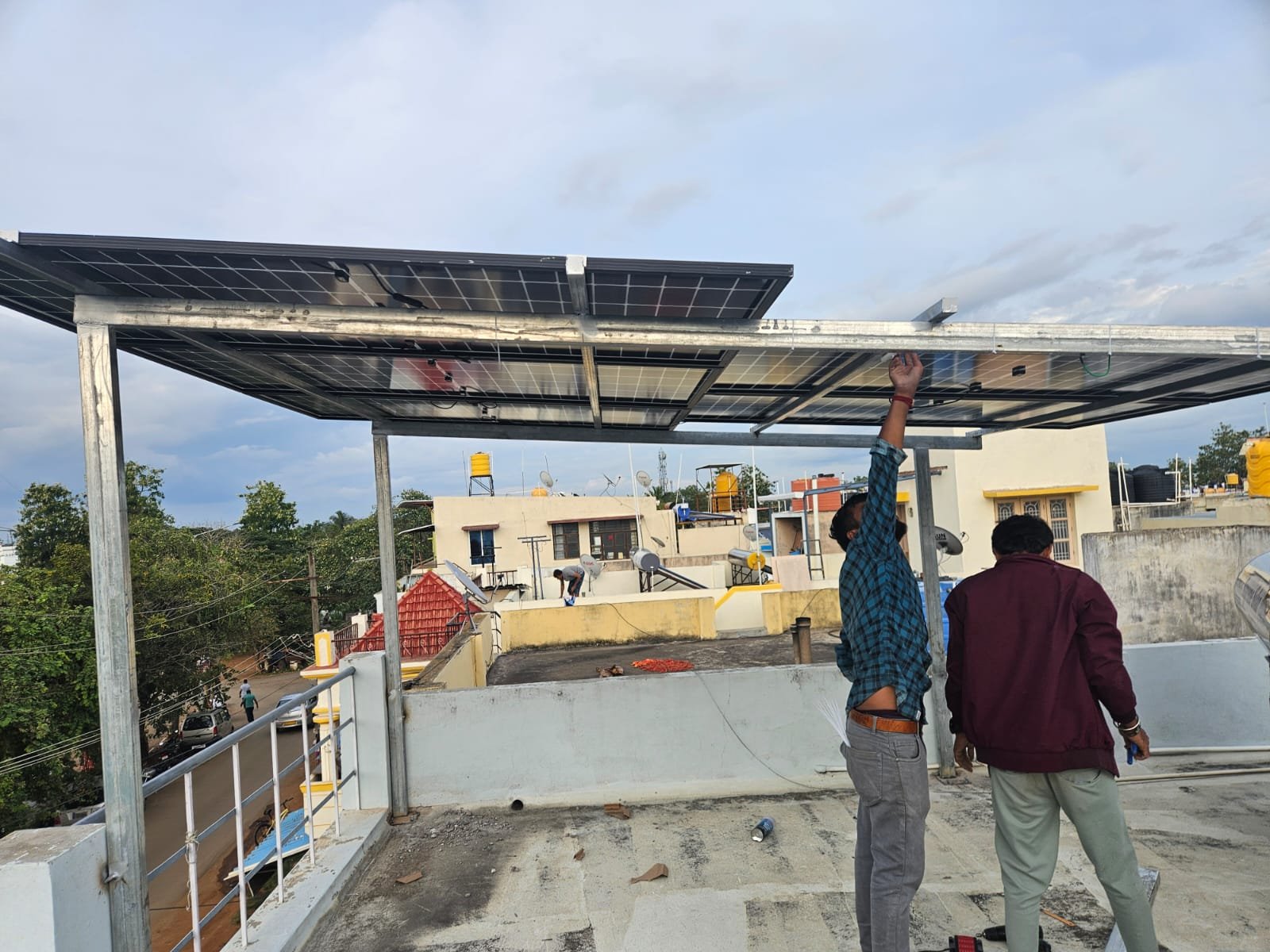 Workers installing solar panels on a residential rooftop for energy savings